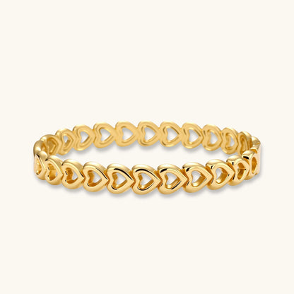 Gold 18K plated stainless steel bangle with continuous open heart links, high-polish finish, on white background.
