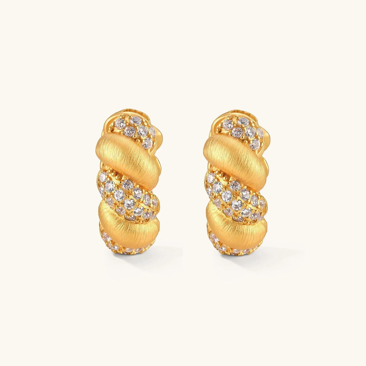 Pair of 18K gold-plated 925 silver huggie hoops with twisted braid texture and pavé cubic zirconia detailing, 15mm.