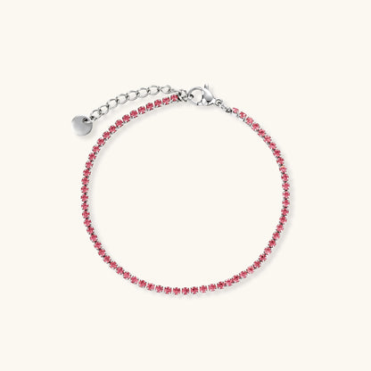 Pink zircon tennis bracelet with silver-tone stainless steel setting and lobster clasp extender chain, flat lay.